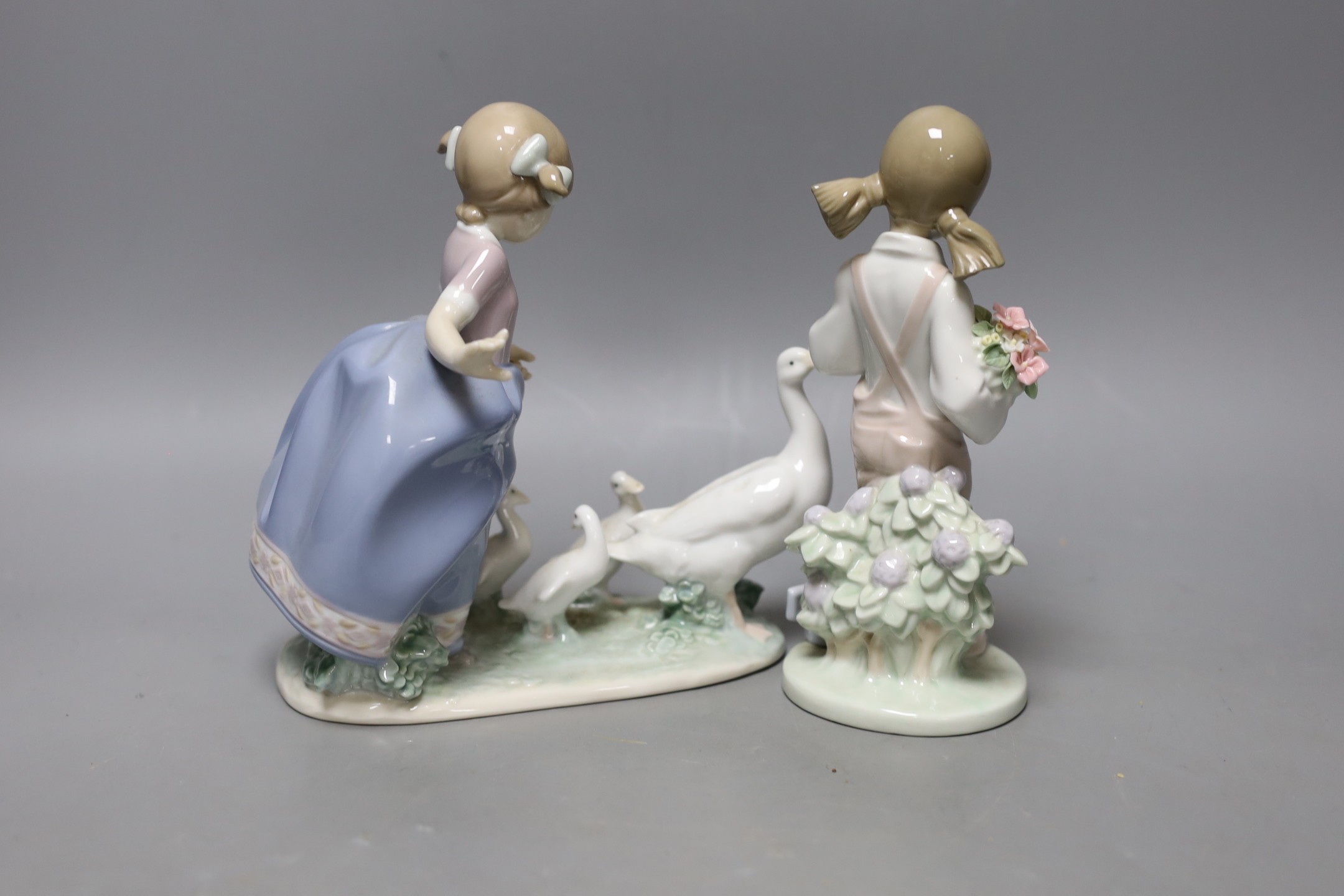 A boxed Lladro figure and another